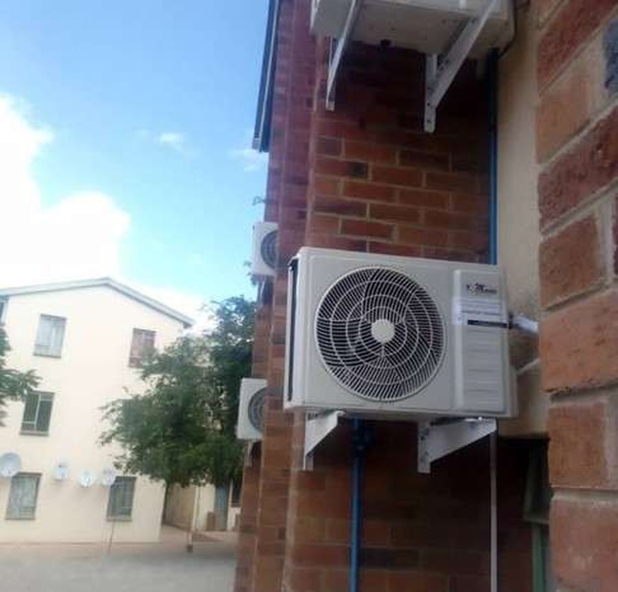 Outdoor condenser mounted on brickwork