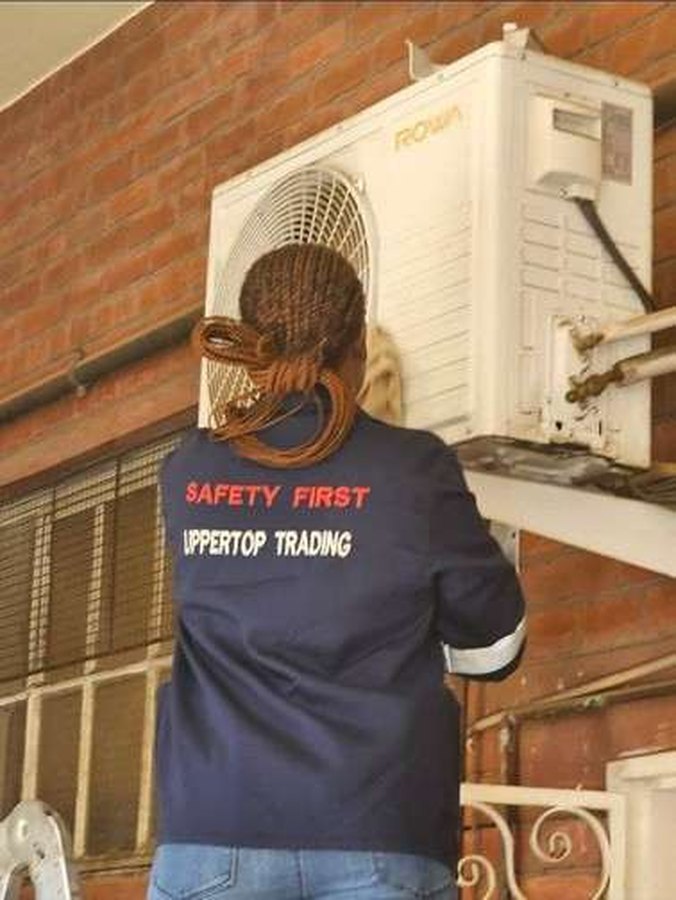 Uppertop technician servicing an outdoor unit
